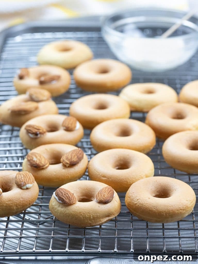 Easter bunny donuts with almond ears on a cooling rack
