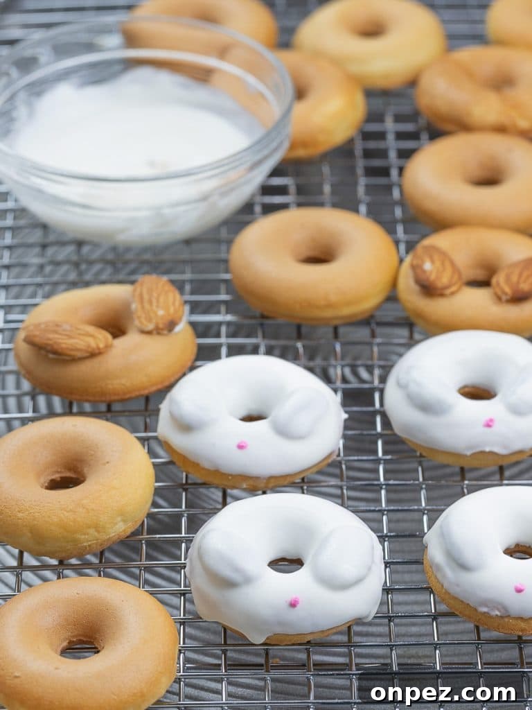 Easter bunny donuts with white candy melt on top of a cooling rack