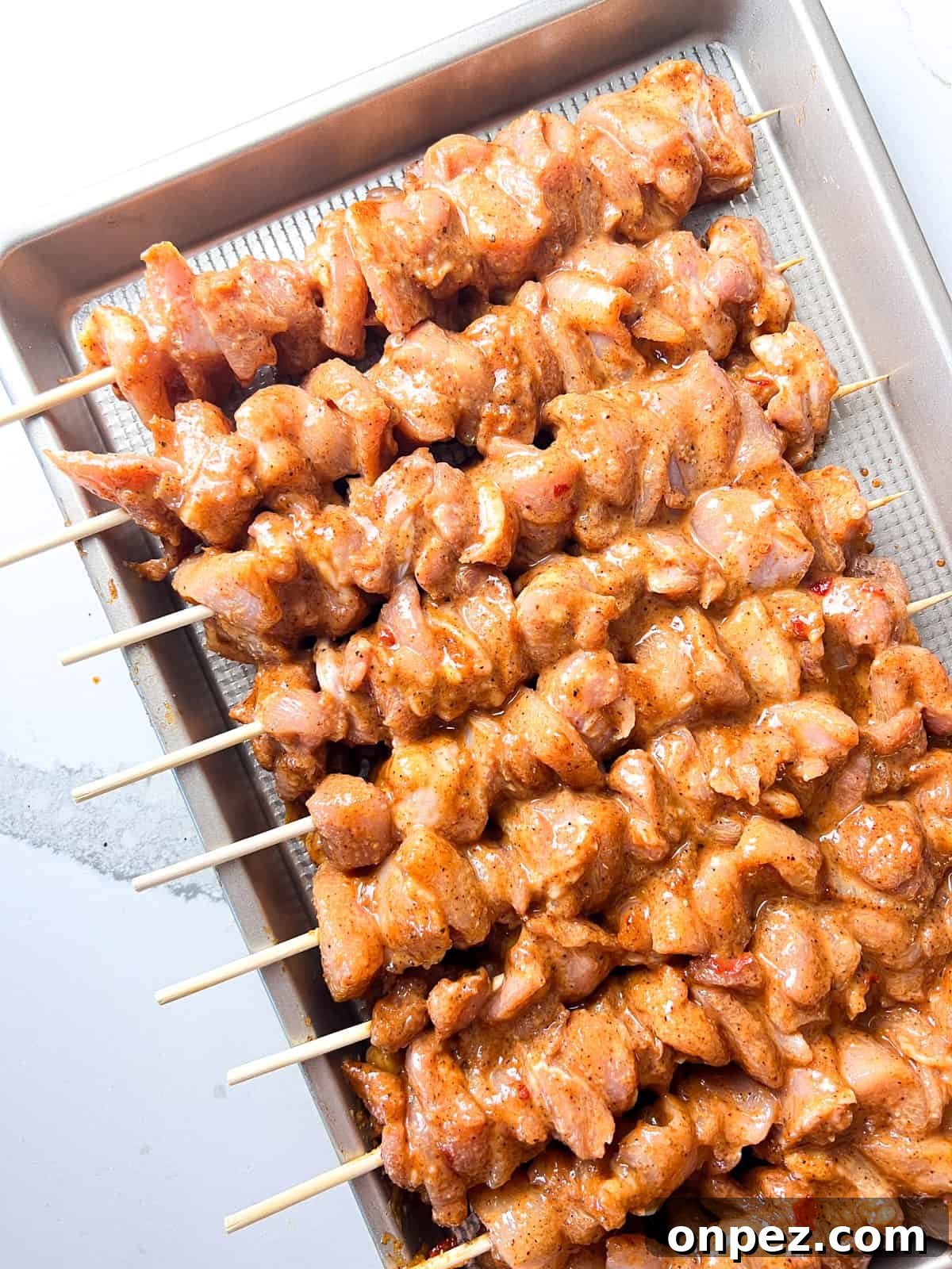 Marinated and skewered chicken thighs.