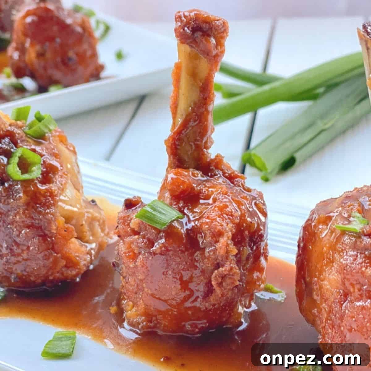chicken drumsticks frenched into lollipops with sauce