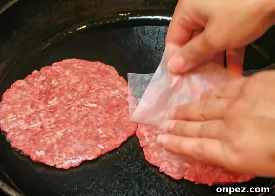 In-N-Out Double-Double Animal Style Copycat Recipe 17 Thin beef patties cooking in a hot skillet
