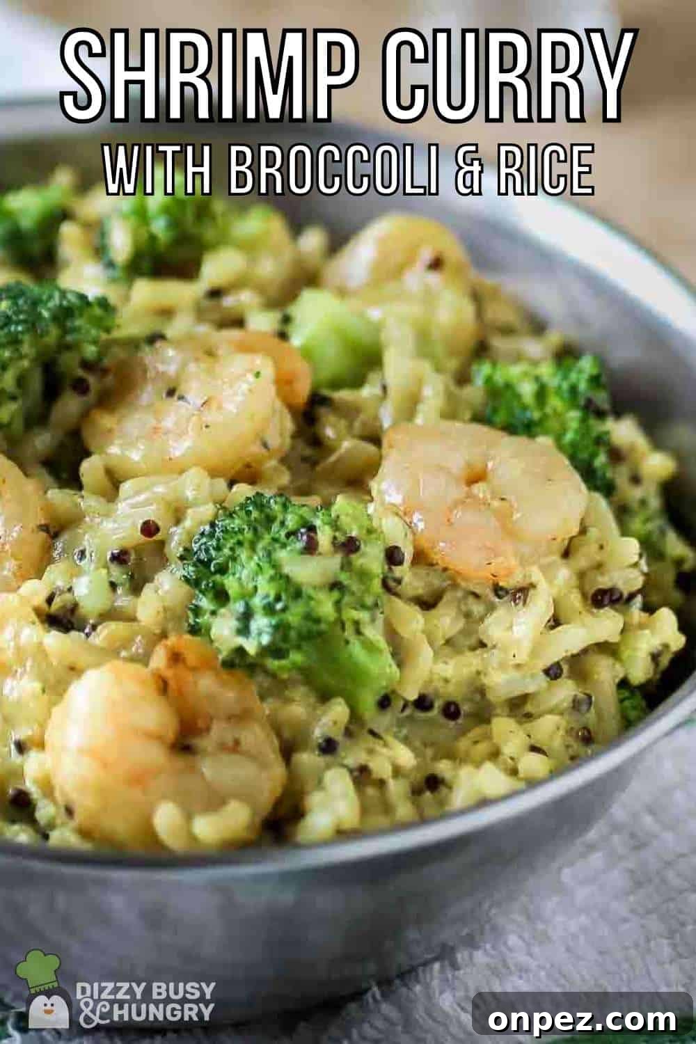 Shrimp and Broccoli Curry over Fragrant Jasmine Rice 2 Side shot of shrimp curry in a metal bowl on a white and green cloth.
