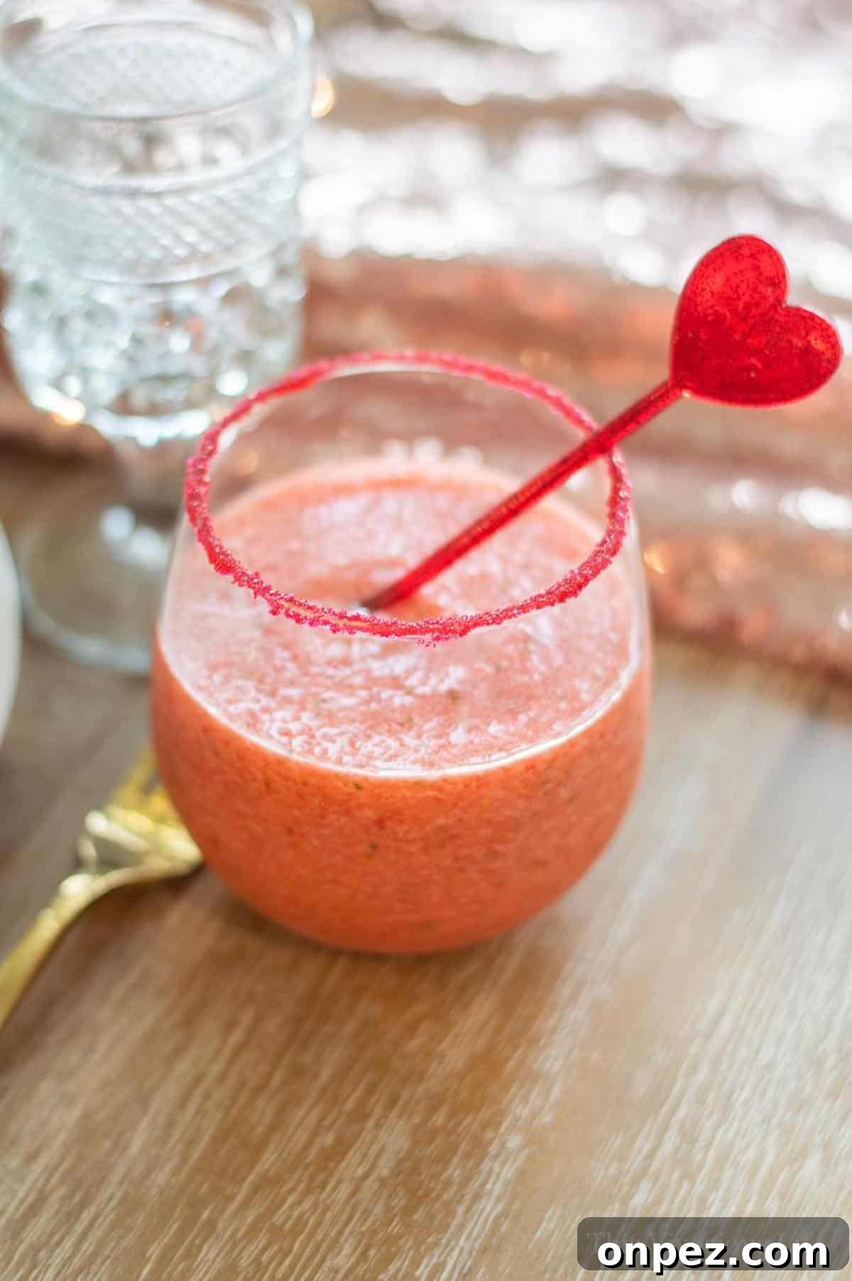 Virgin Strawberry Margarita Mocktail in a cup with red sugar rim