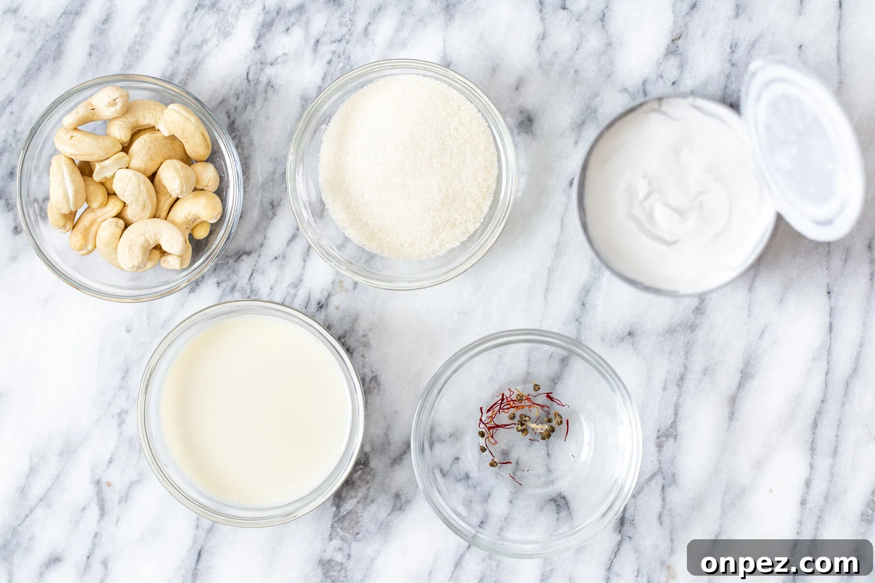 Ingredients for the soaking rasmalai milk in bowls