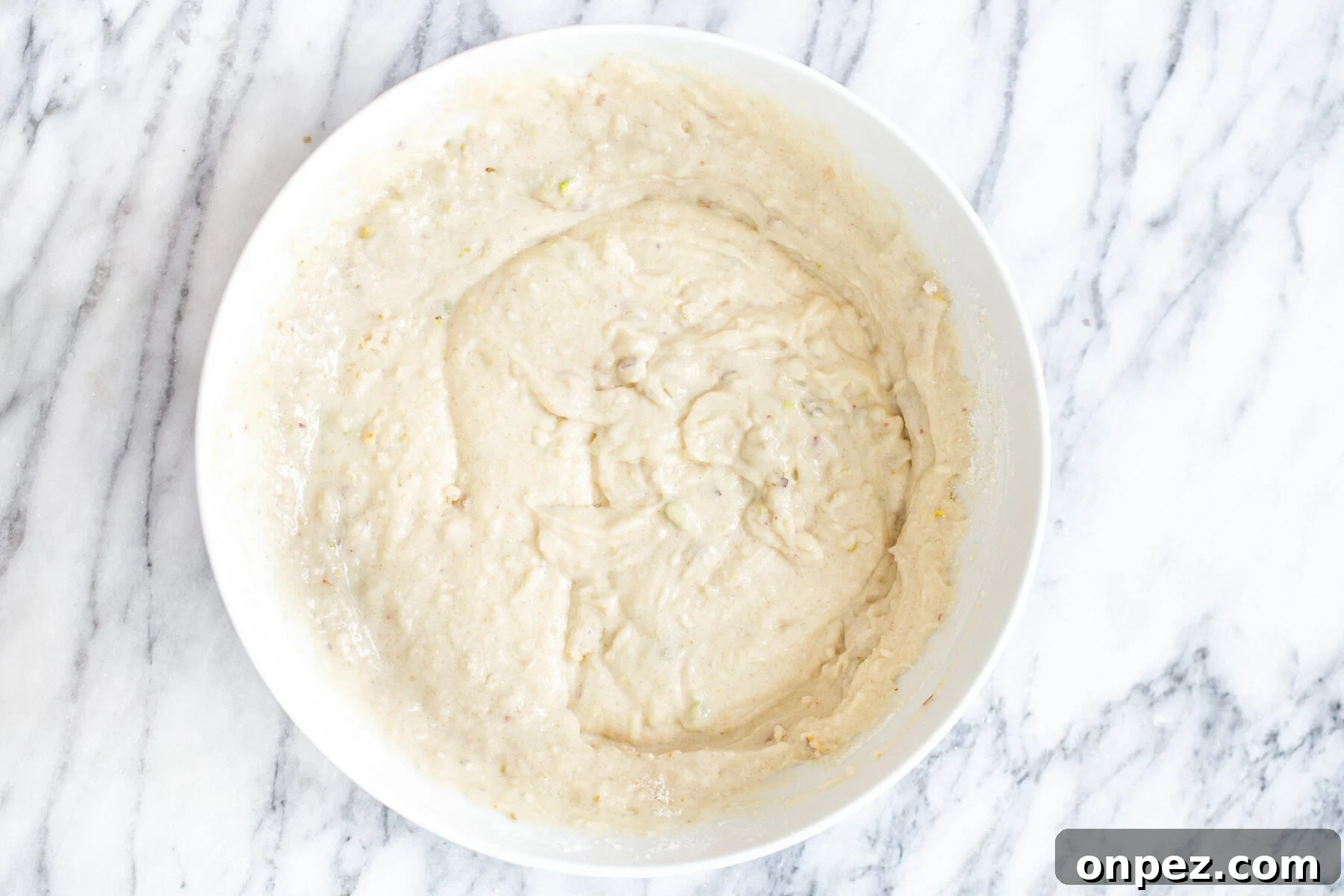 tres leches cake batter in a white bowl
