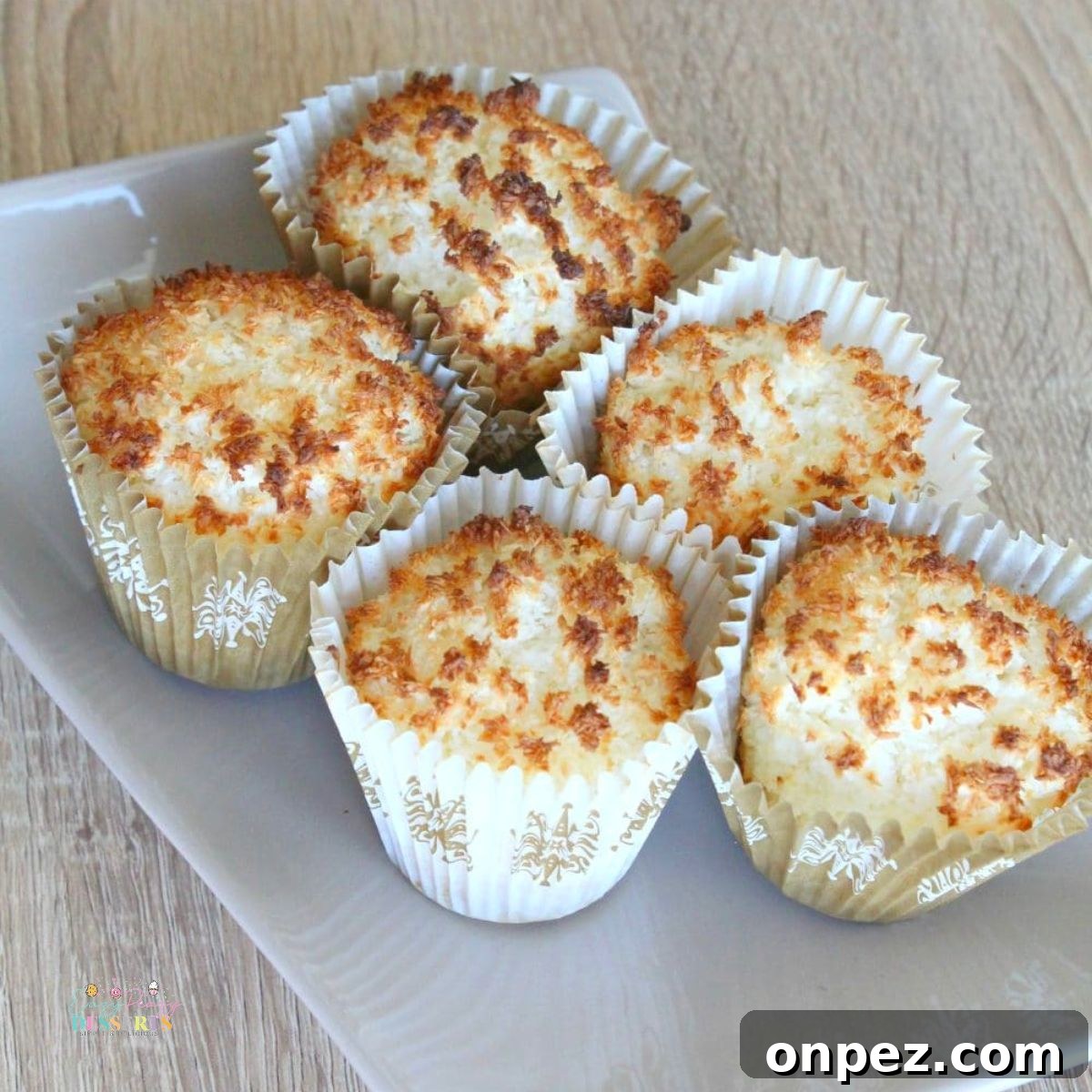 Fluffy Gluten-Free Coconut Muffins 3 Close up image of easy coconut muffins on a dessert dish