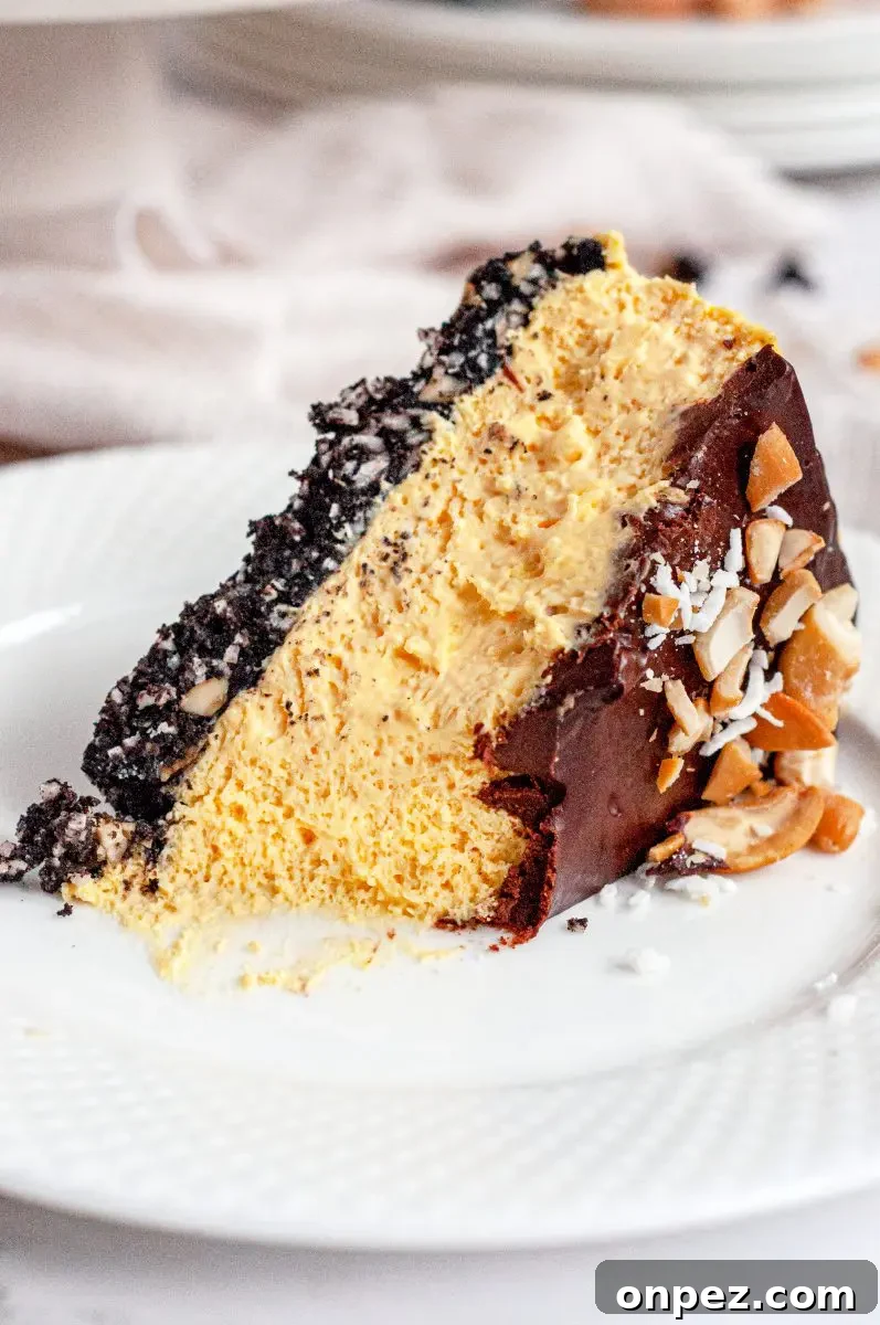 No-Bake Vegan Gluten-Free Nanaimo Bar Cheesecake 5 a slice of no-bake nanaimo bar cheesecake laying on its side on a white late. It looks like a fork has taken a bite out of the end.
