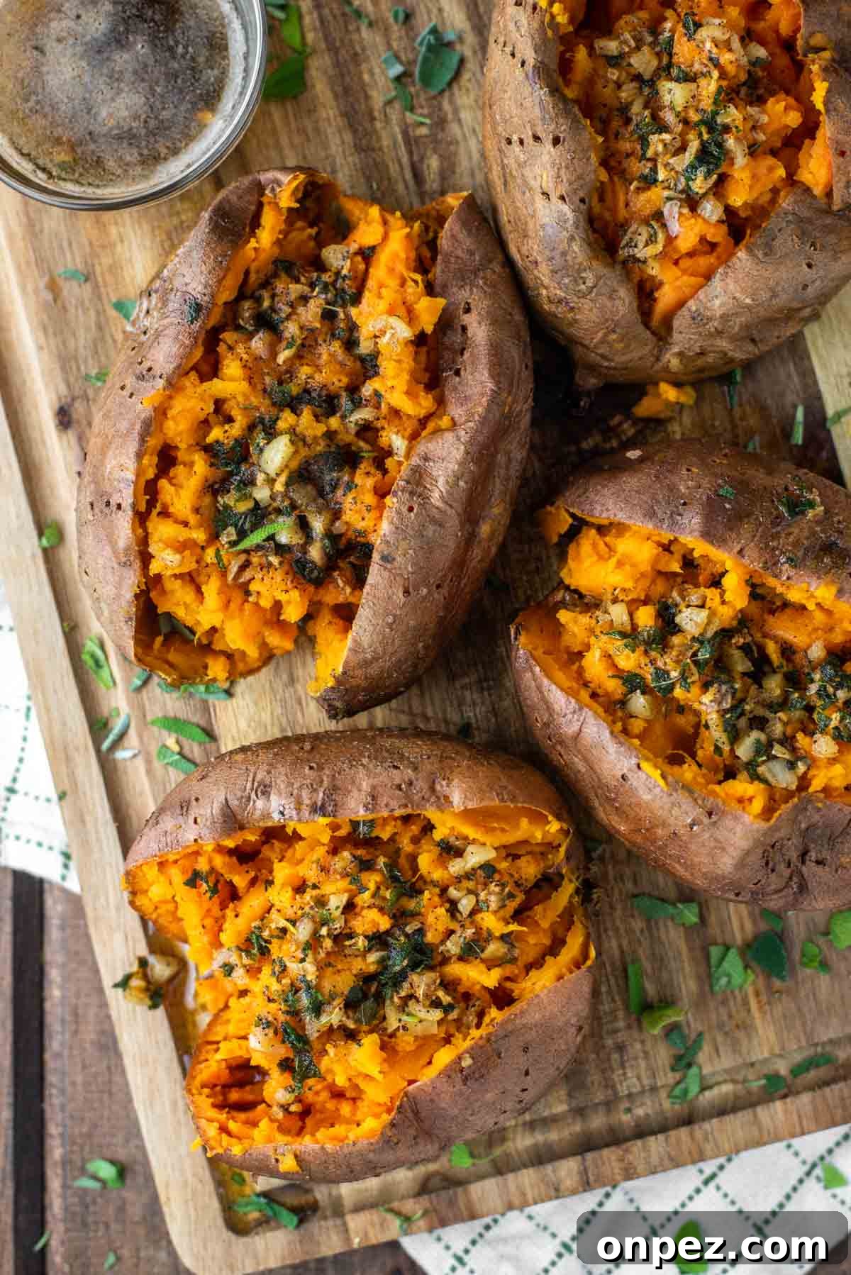4 smoked sweet potatoes on wood board.