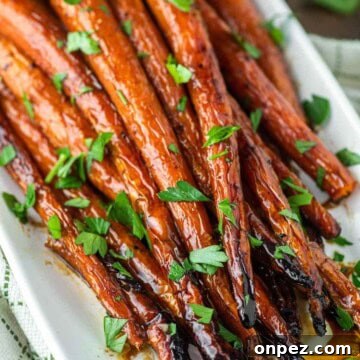 Maple roasted carrots on white plate.
