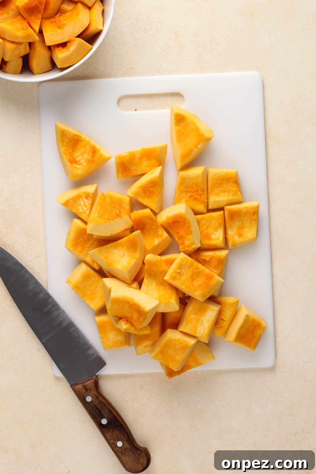 a knife and cut pumpkin on a cutting board