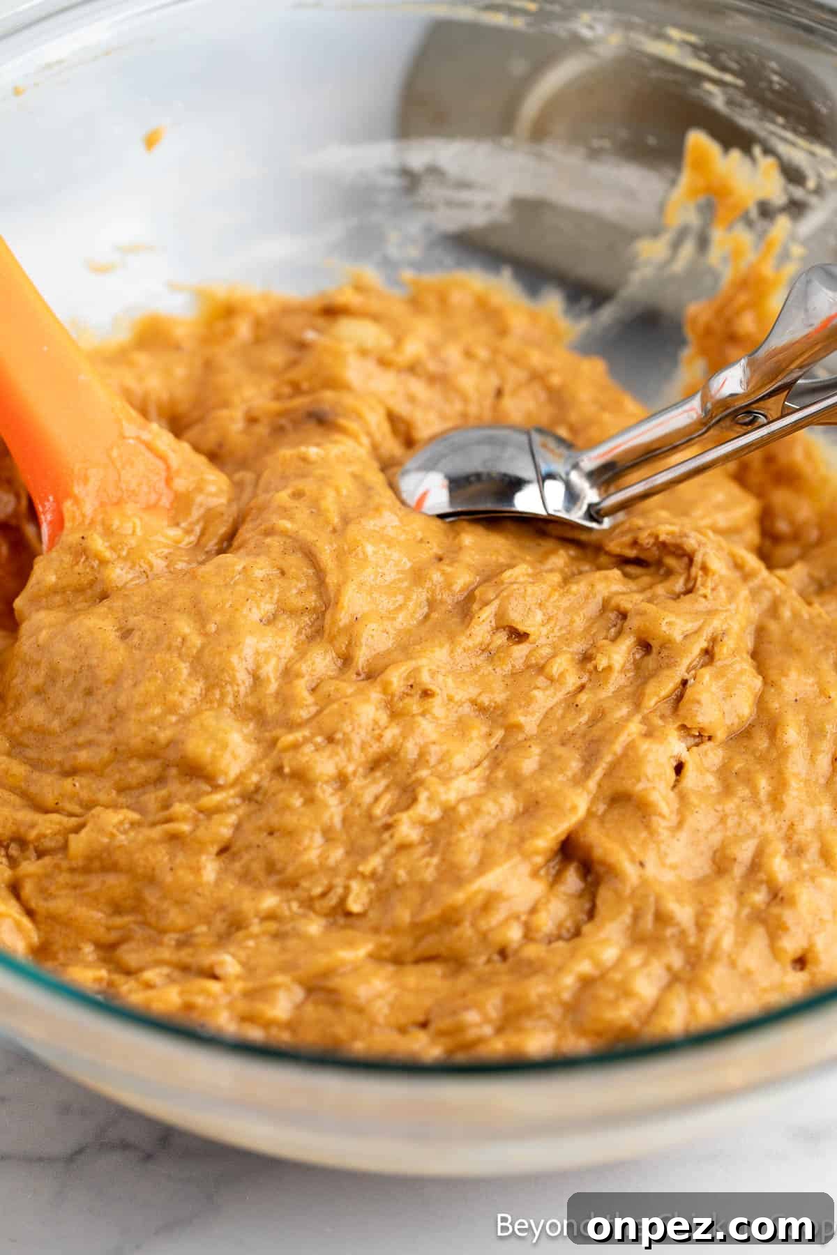 Pumpkin Banana Muffins Recipe with Warm Fall Spices 4 Scooping muffin batter with an ice cream scoop.