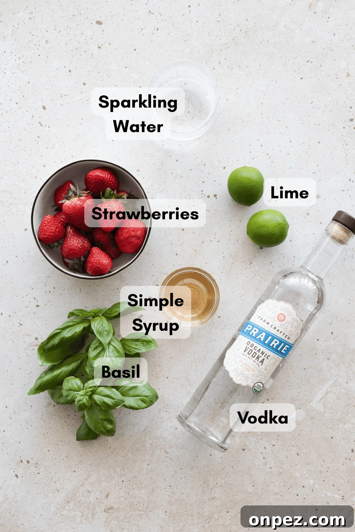 Ingredients for a strawberry basil vodka cocktail. 