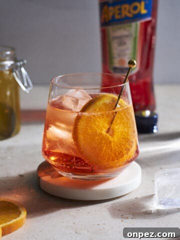 Aperol Soda in a cocktail glass garnished with an orange slice.