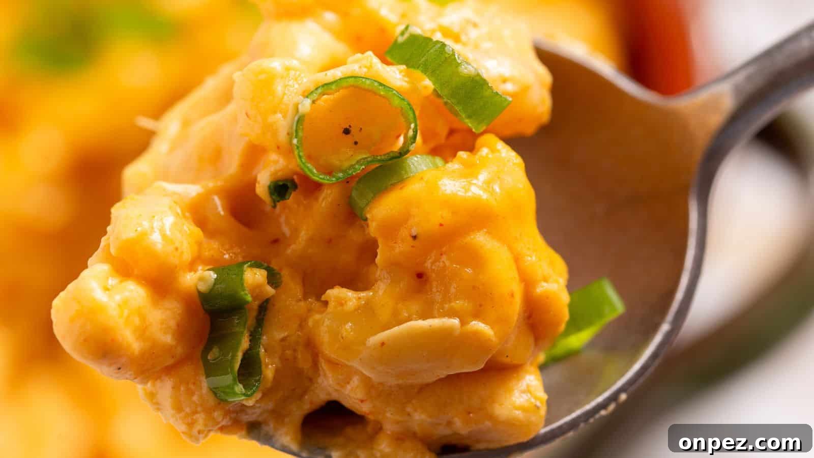 A bowl of macaroni and cheese in front of a slow cooker.