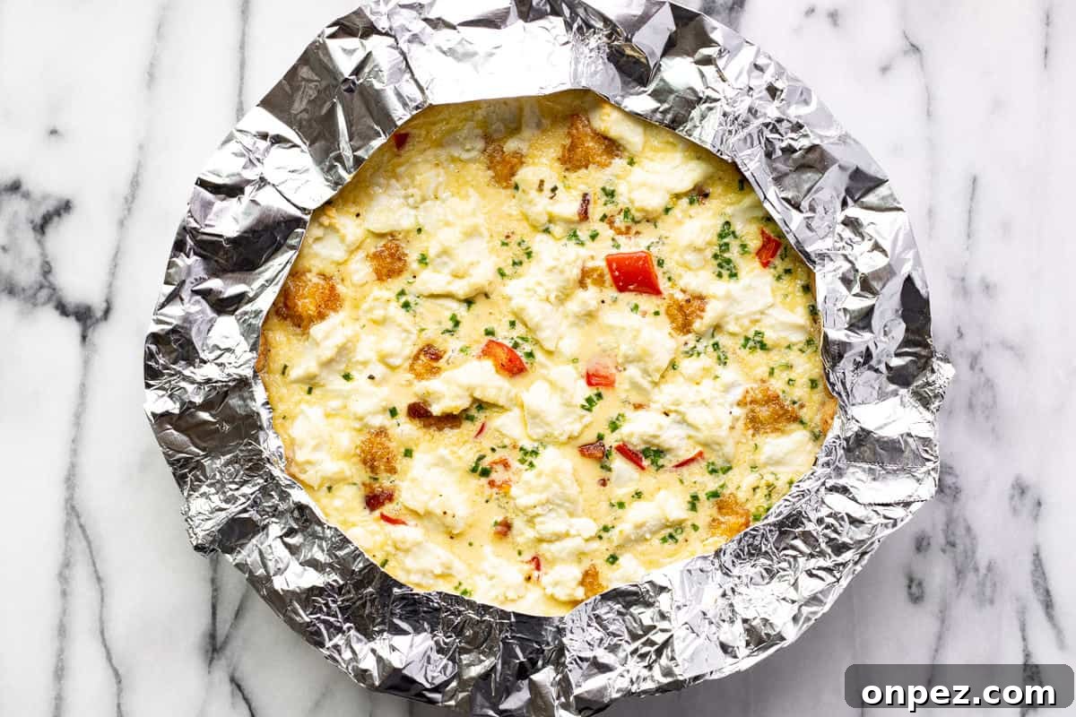 Quick Breakfast Quiche Recipe 9 A tin foil ring around a breakfast quiche.