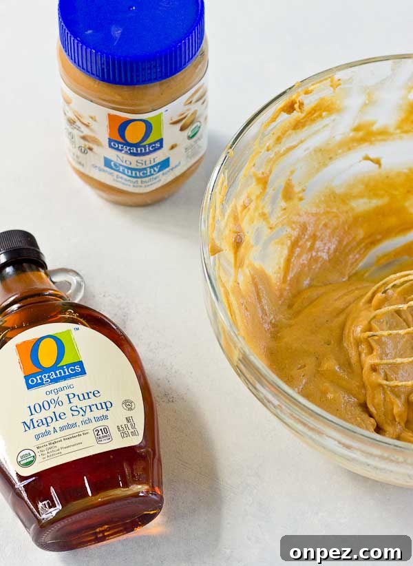 Spoon spreading peanut butter on a pancake