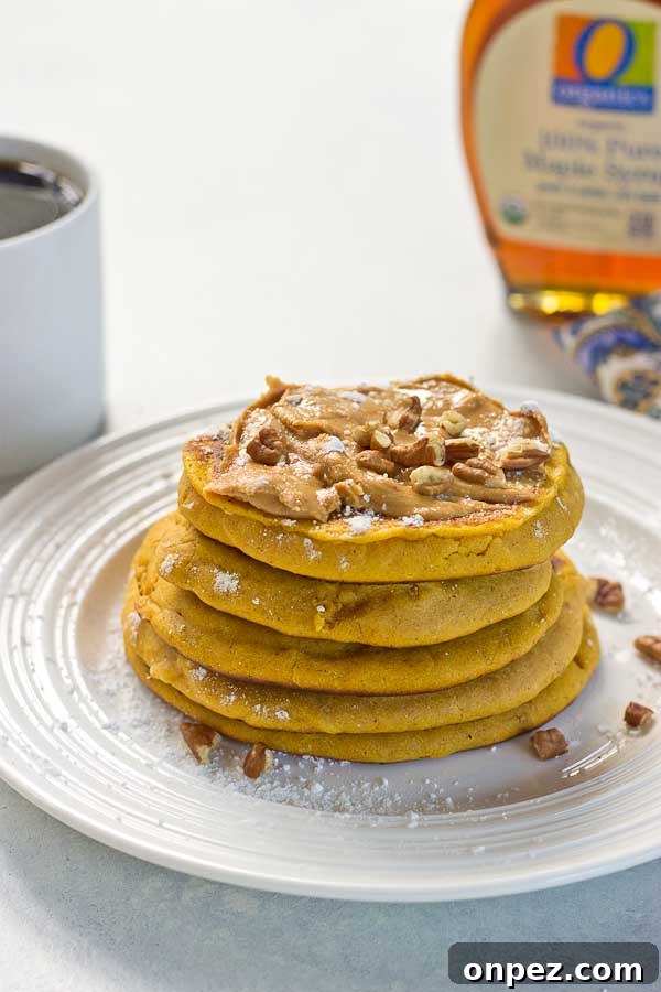 Griddle with pancakes cooking, golden edges