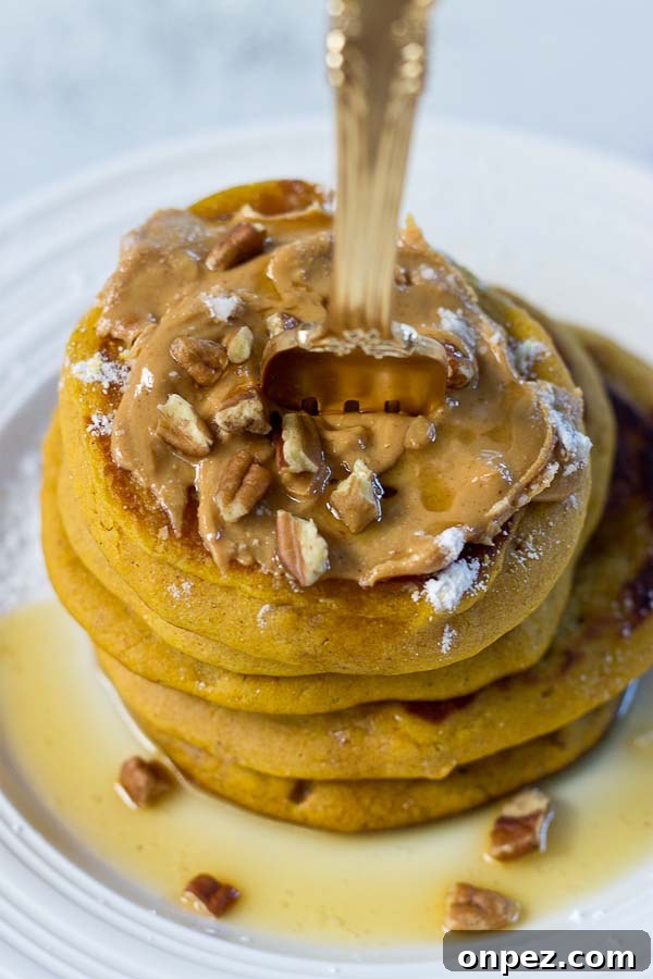 Stack of Peanut Butter Pumpkin Pancakes with maple syrup