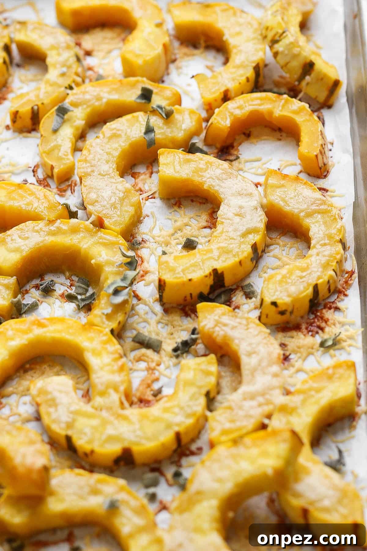 Crispy Roasted Delicata Squash with Parmesan 6 Roasted delicata squash on a baking sheet.
