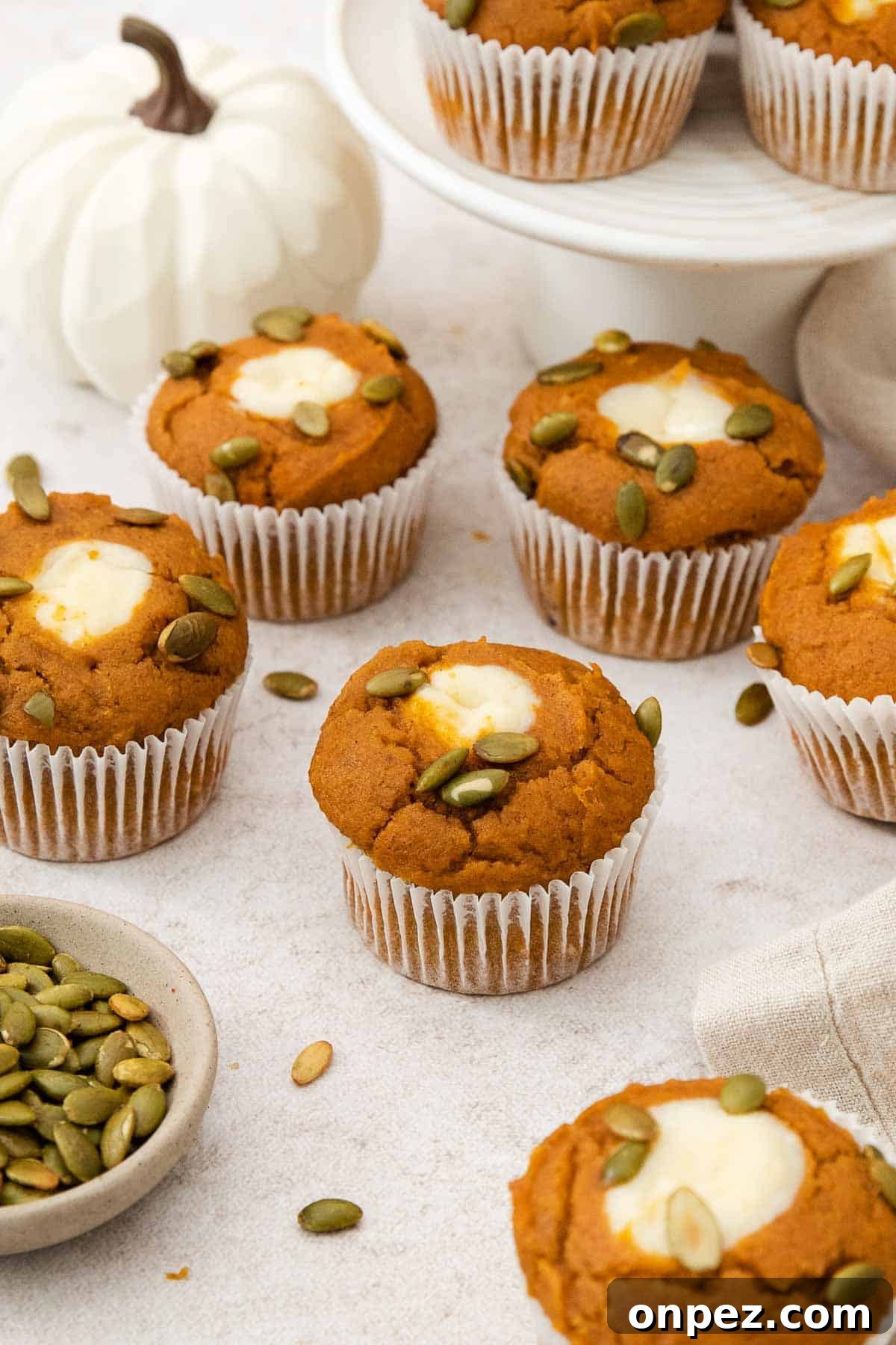 Gluten-free pumpkin cream cheese muffins on a countertop.