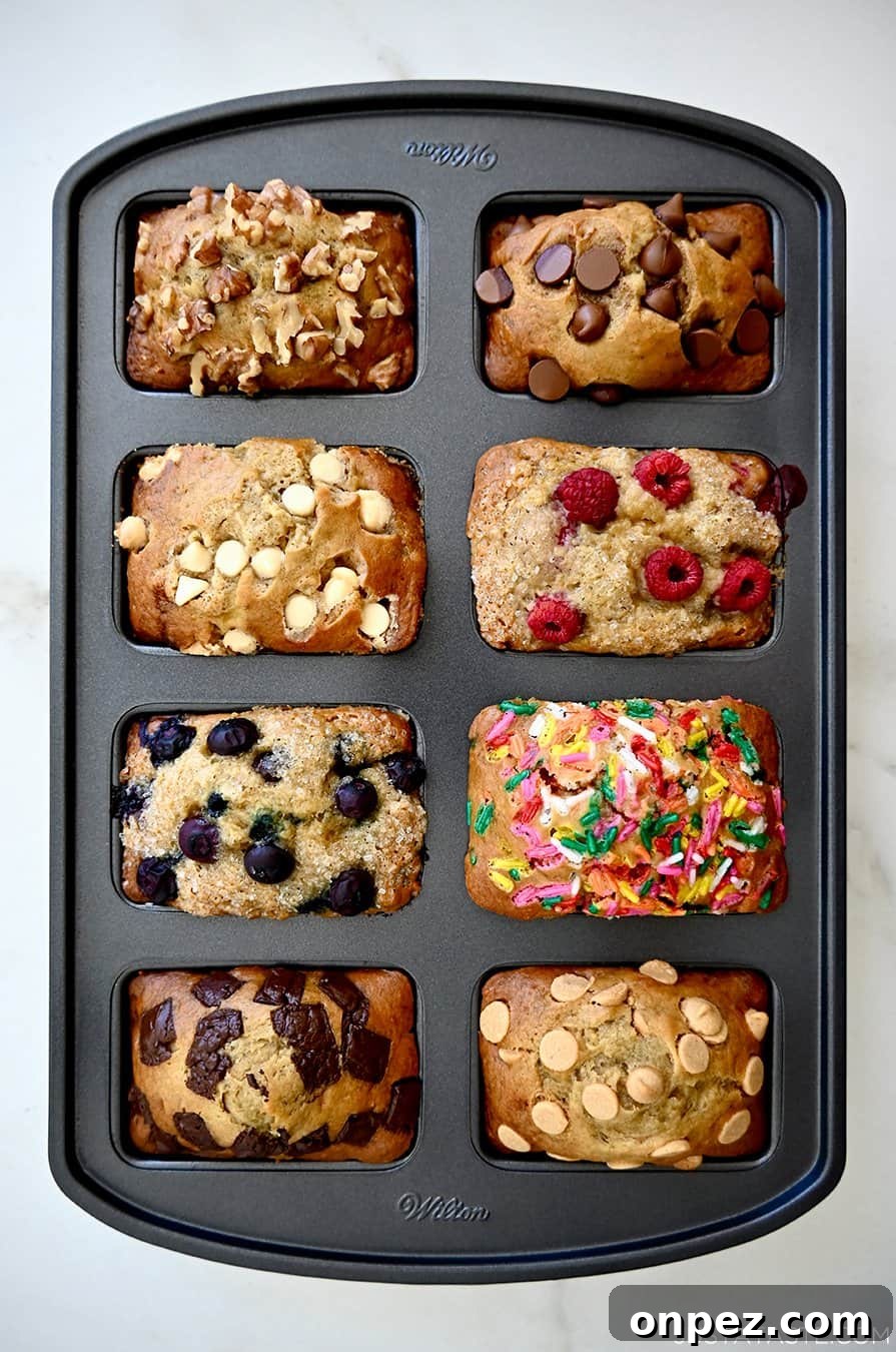 A top-down view of freshly baked mini banana bread loaves in a pan