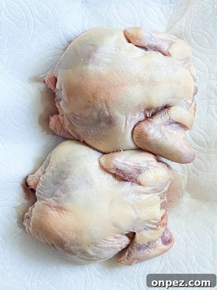 Crispy Air Fryer Cornish Hens Recipe with Herb Butter 5 raw cornish game hens on paper towels