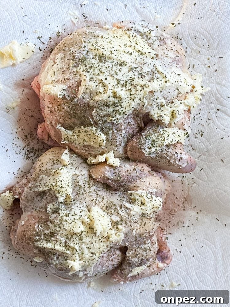 Crispy Air Fryer Cornish Hens Recipe with Herb Butter 7 raw cornish game hens on a plate with butter and seasonings