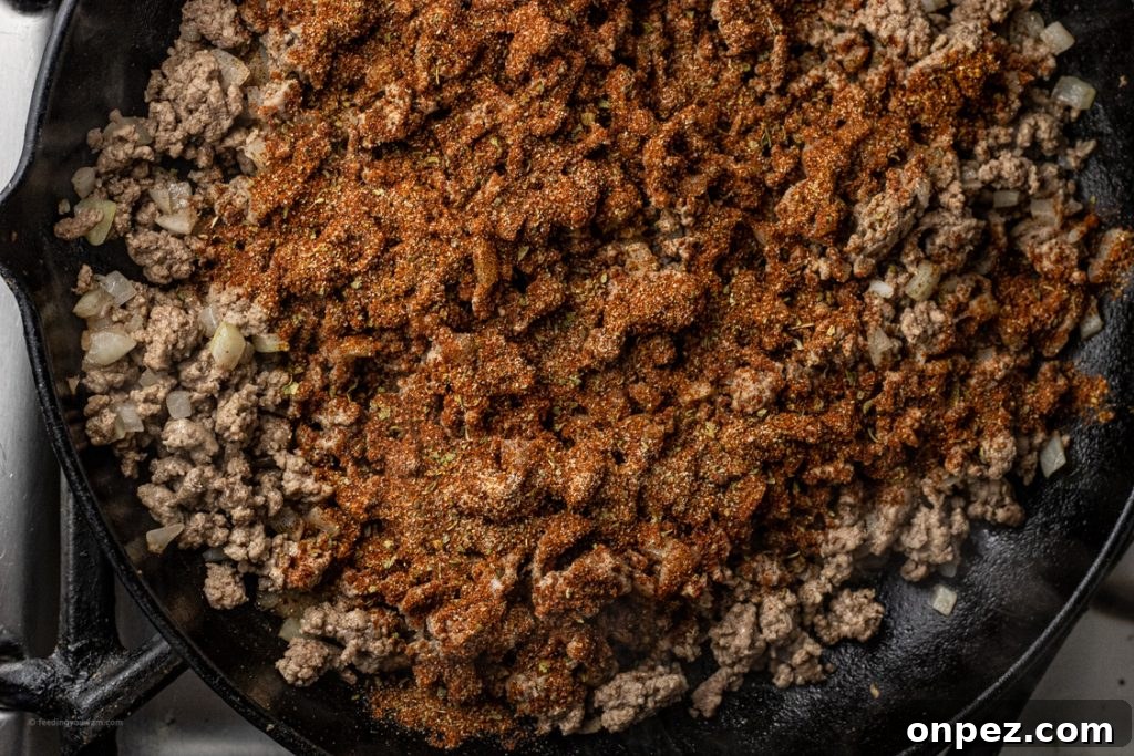 seasoned, cooked ground beef in a cast iron pan