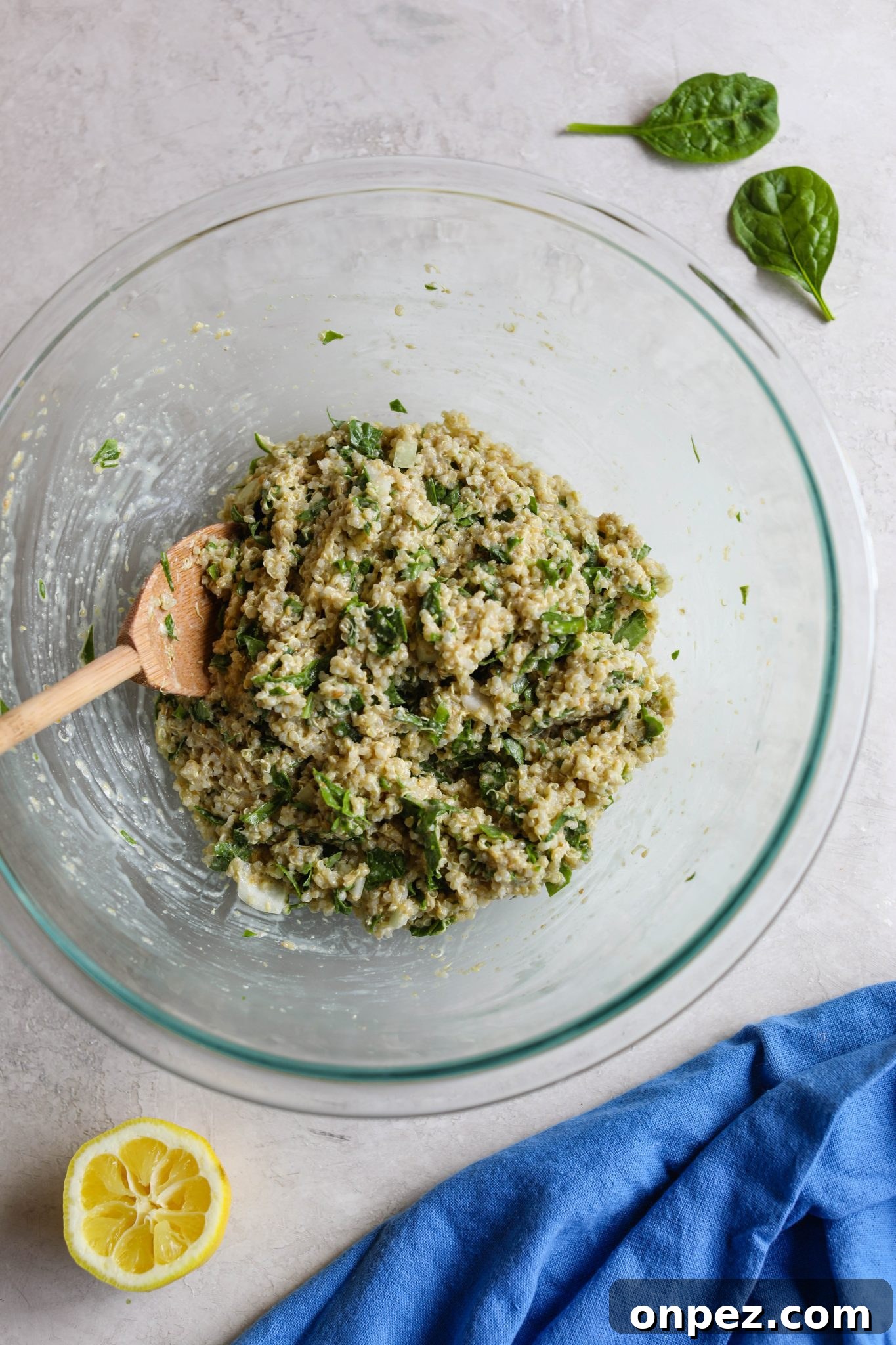 Quinoa Cakes mixed in bowl with wooden spoon by Flora & Vino