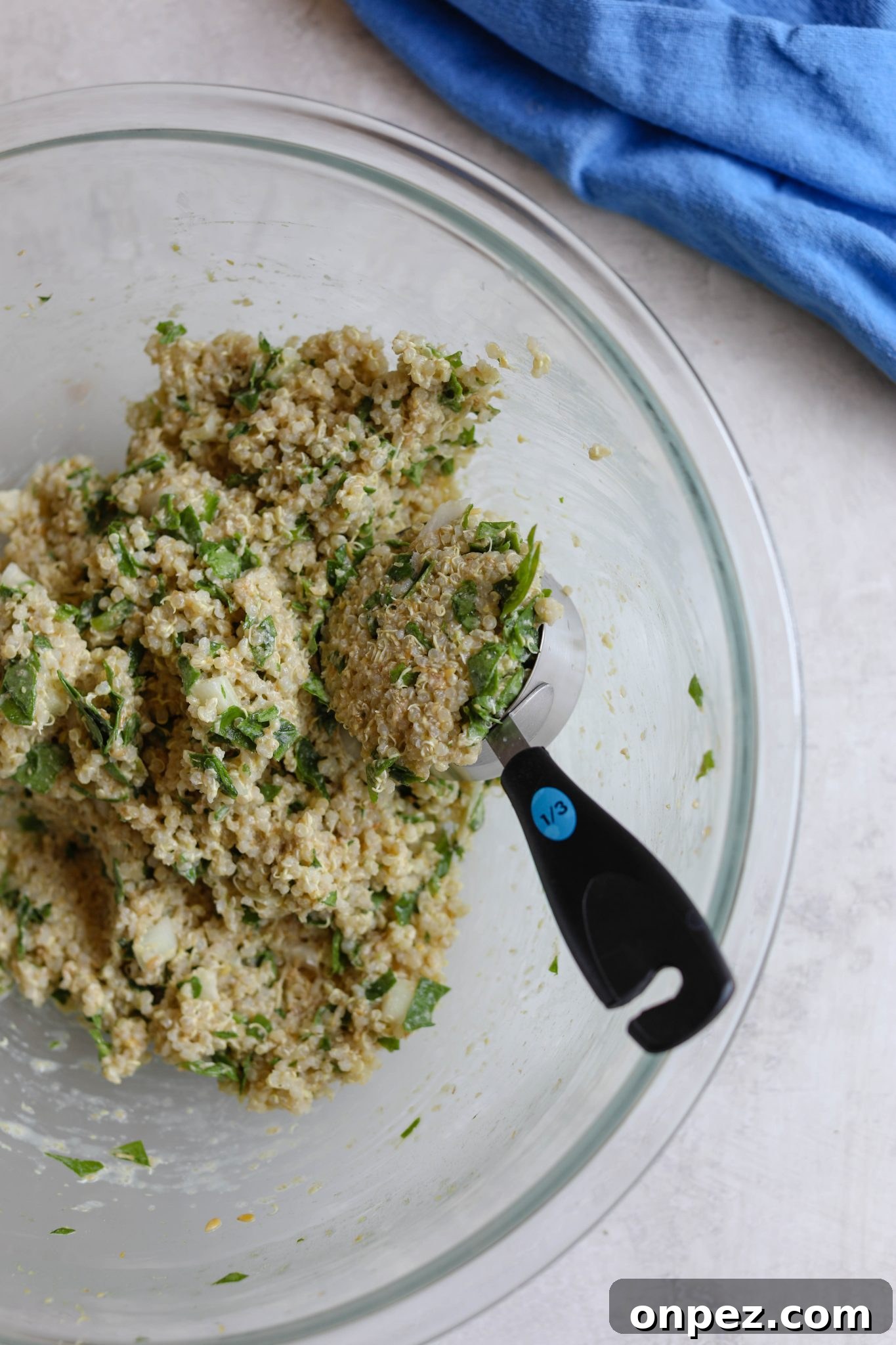Quinoa Cakes mixed in bowl with measuring cup by Flora & Vino
