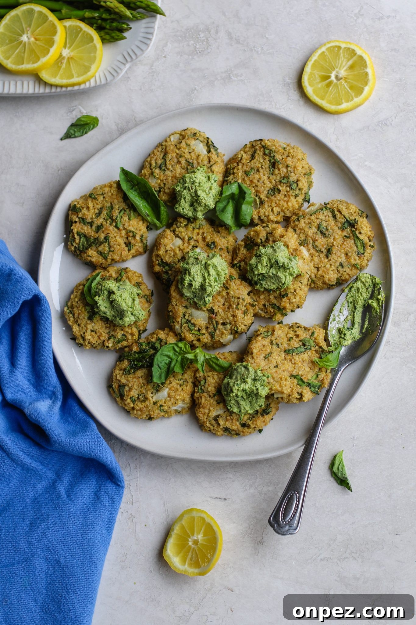 Quinoa Cakes served on plate dollops of basil pesto by Flora & Vino