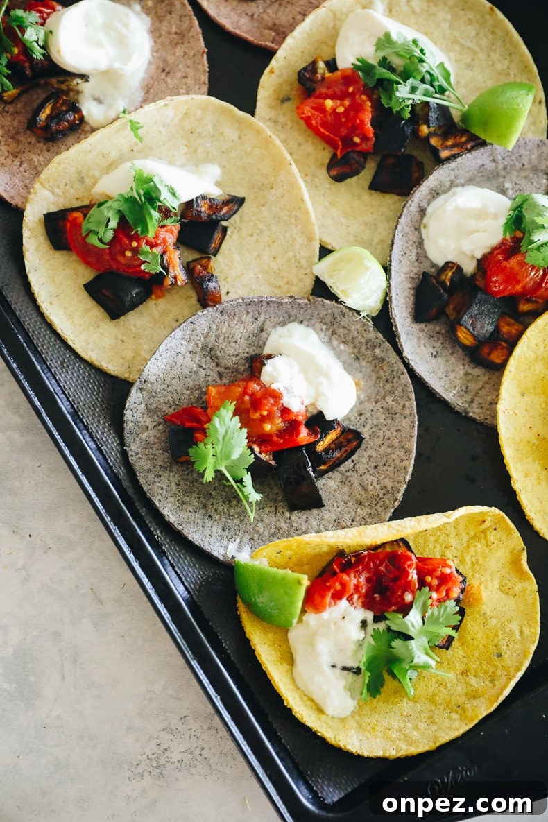 eggplant tacos laid out on a baking sheet
