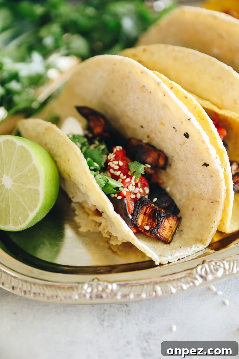 Roasted eggplant tacos on a silver tray