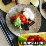 eggplant tacos laid flat on a baking tray