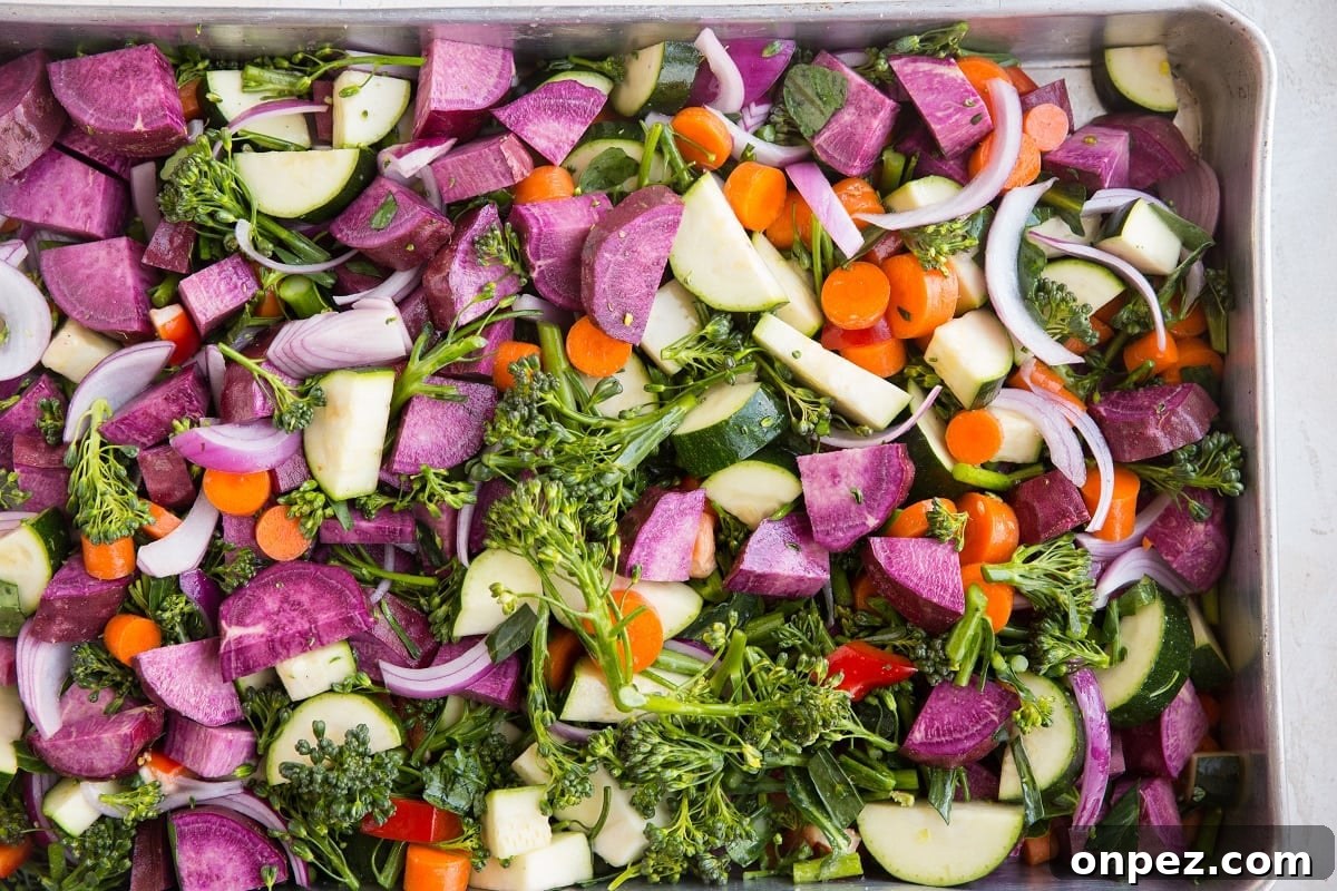 huge casserole dish filled with raw vegetables, ready to be roasted