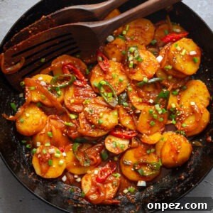 Spicy potatoes braised in a skillet.