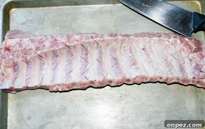Sticky Asian Baked Pork Ribs Recipe 5 Sticky Asian Baked Pork Ribs shown raw with crosshatch on membrane