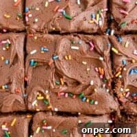 Classic Depression-Era Chocolate Cake (No Eggs, No Milk) 4 a close up of chocolate fudge brownies with sprinkles.