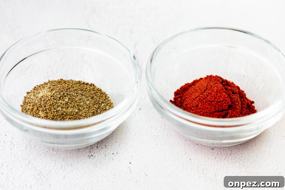 Close-up of celery salt and paprika on a concrete surface.