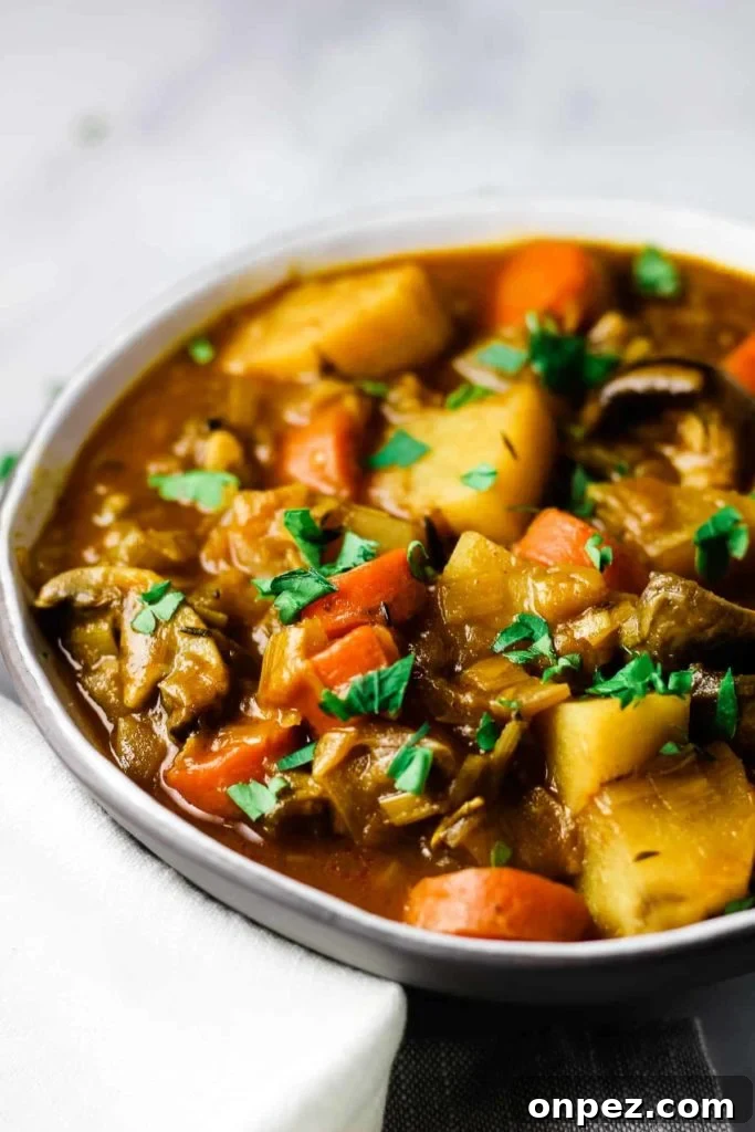 A bowl of vegetable stew sprinkled with parsley