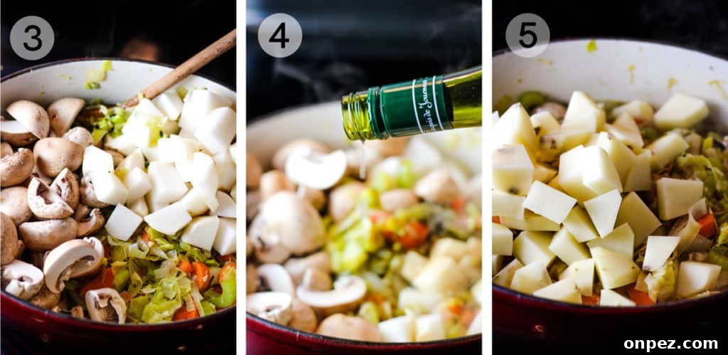 Vegetables cooking in a large pot with wine being poured in