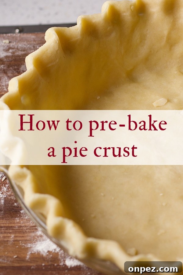 Pie dough that's been fitted into a glass pie plate and is ready to be baked.