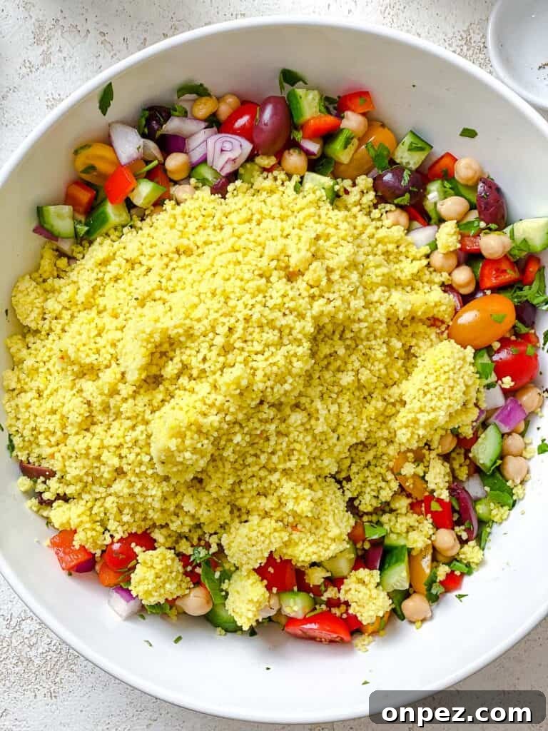 process shot of couscous being added to white bowl