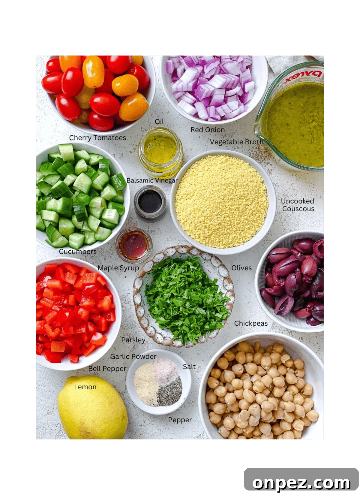 ingredients for Mediterranean Couscous Salad measured out against a white surface