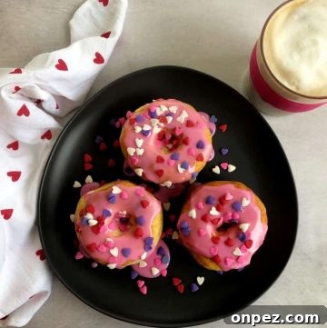 Valentine donuts on a plate with latte.