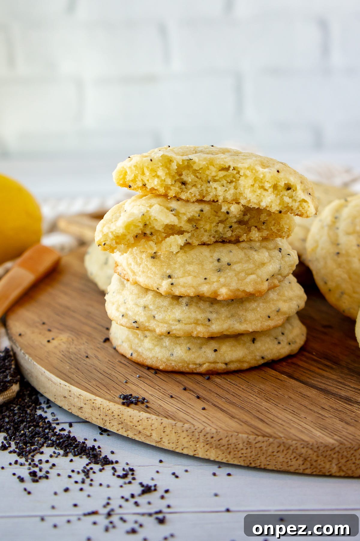 Lemon Poppy Seed Cookies with Bright Zesty Flavor 2 a stack of poppy seed cookies with the top one broken in half and open.