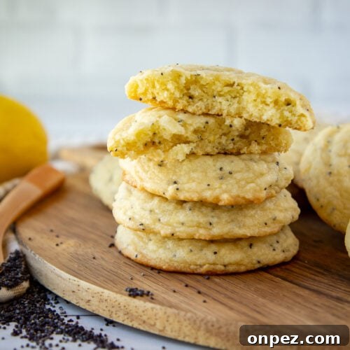a stack of poppy seed cookies on a round wooden board.