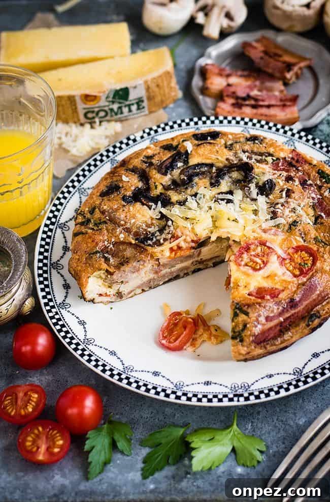 Fully Loaded Deep Dish Breakfast Frittata with Comté Cheese, Bacon, Sausages, Tomatoes and Mushrooms