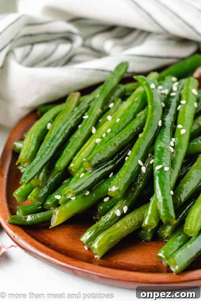 Honey Garlic Glazed Green Beans 5 Honey garlic green beans on a brown plate.