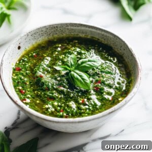 Chimichurri sauce in a white bowl with chili flakes.
